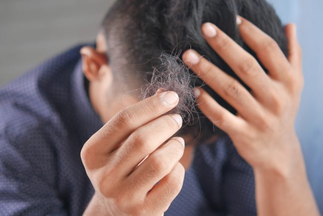 man hold his list hair close up