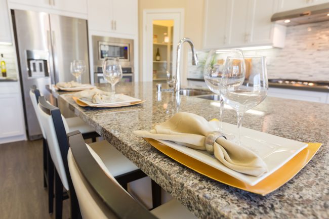 Abstract of Beautiful Kitchen Granite Counter Place Settings and Chairs.